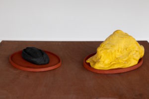 Bread, Butter - carbonised loaf of bread, road marking thermoplastic, glass ballotini, terracotta platter, 2016